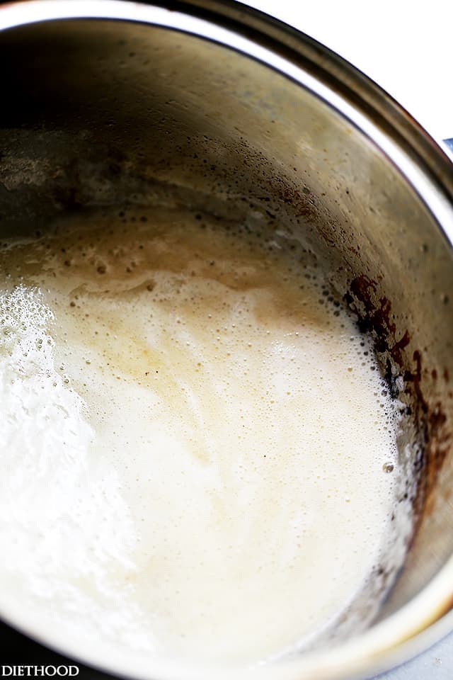 Flour and butter cooking into a roux inside a saucepan.