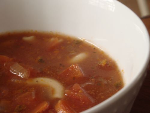 Tomato-based vegetable stew in a white bowl