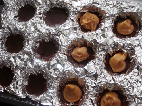 Peanut butter in a foil-lined muffin tin