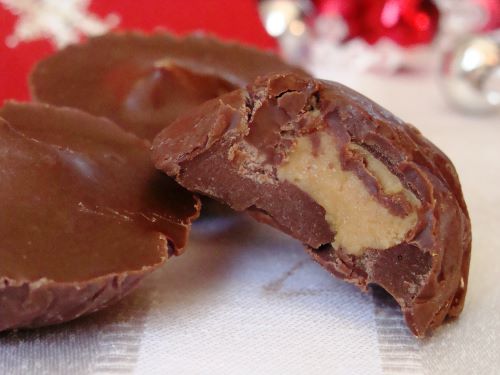 A few homemade chocolate covered peanut butter cups with a bite out of one