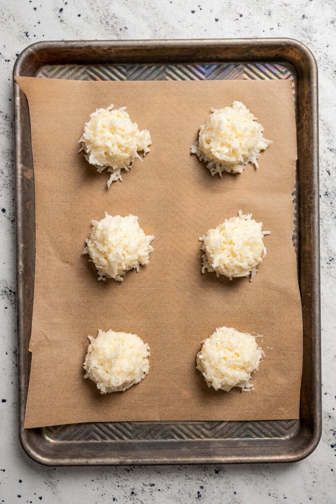 Scooping coconut macaroons onto the baking tray. 