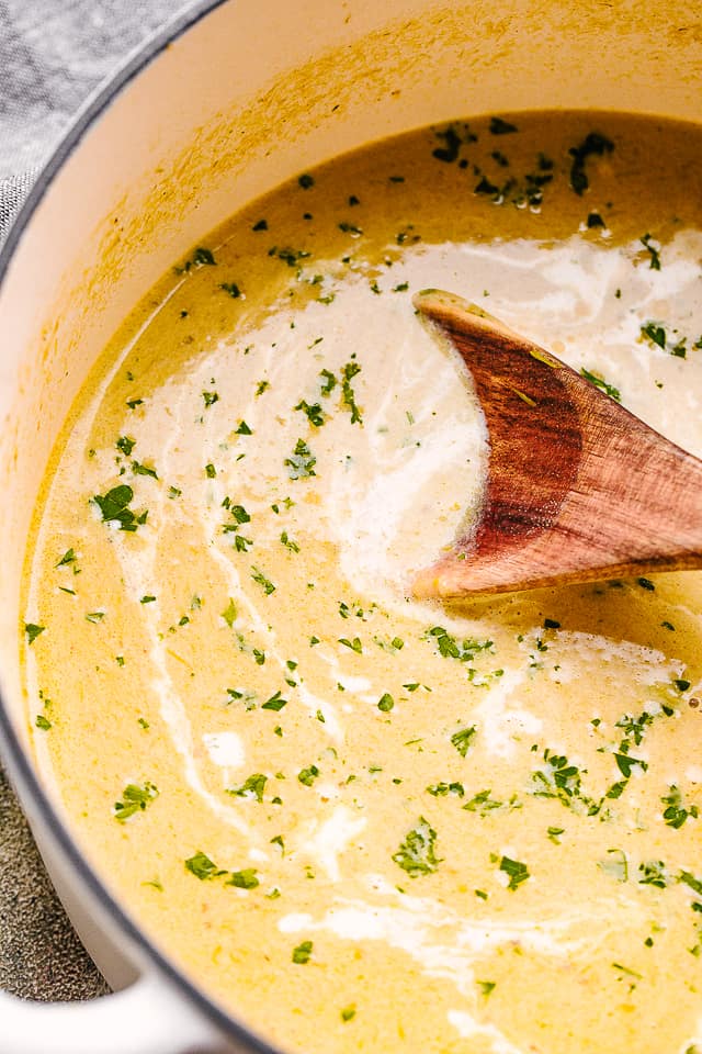 stirring asparagus soup in a dutch oven