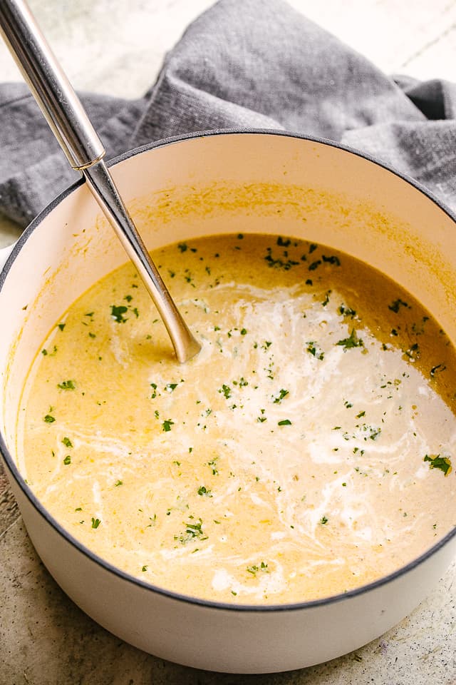 asparagus soup in a pot with a ladle