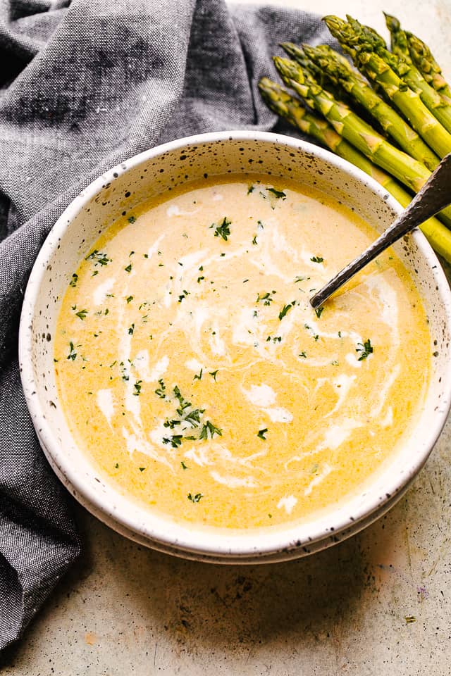 asparagus soup in a bowl with a spoon