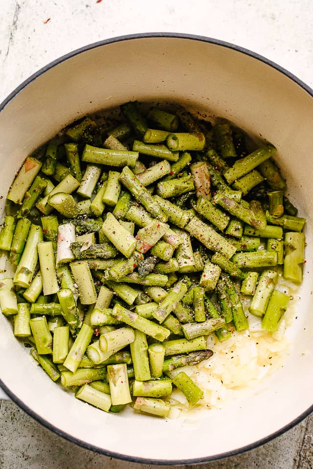 Asparagus pieces in a Dutch oven. 