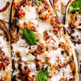 Sausage stuffed eggplants covered in melty cheese.