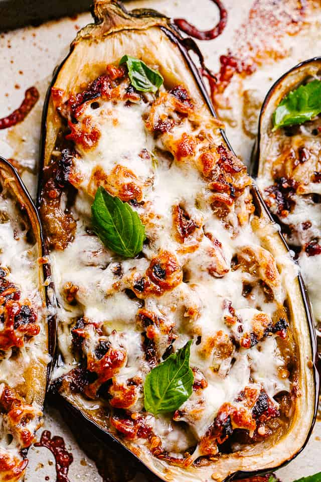 Sausage stuffed eggplants covered in melty cheese.