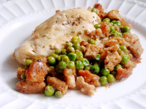Chicken Breast with Peas and Croutons on a white plate