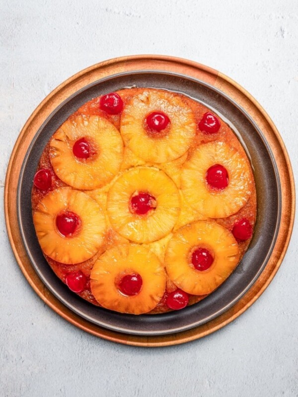 Baked and inverted pineapple upside down cake on a plate.