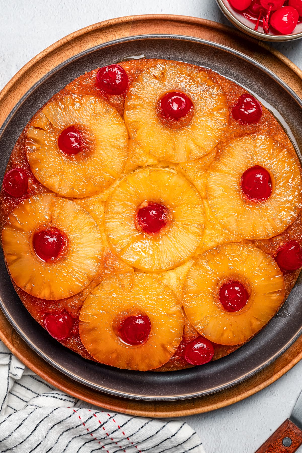 Close-up overhead view of a pineapple upside-down cake on a plate.