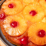 Close-up of a pineapple upside down cake on a plate.