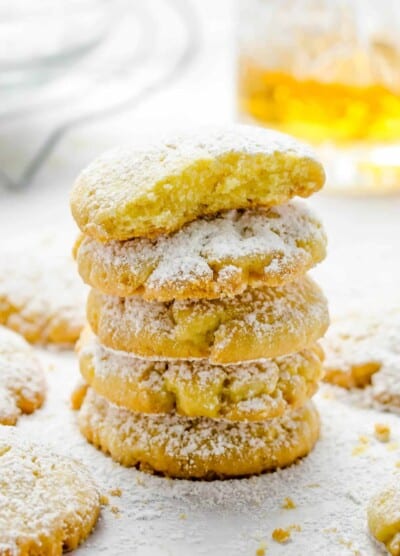 A stack of baked Gurabii shortbread cookies, with a bite missing from the top cookie.