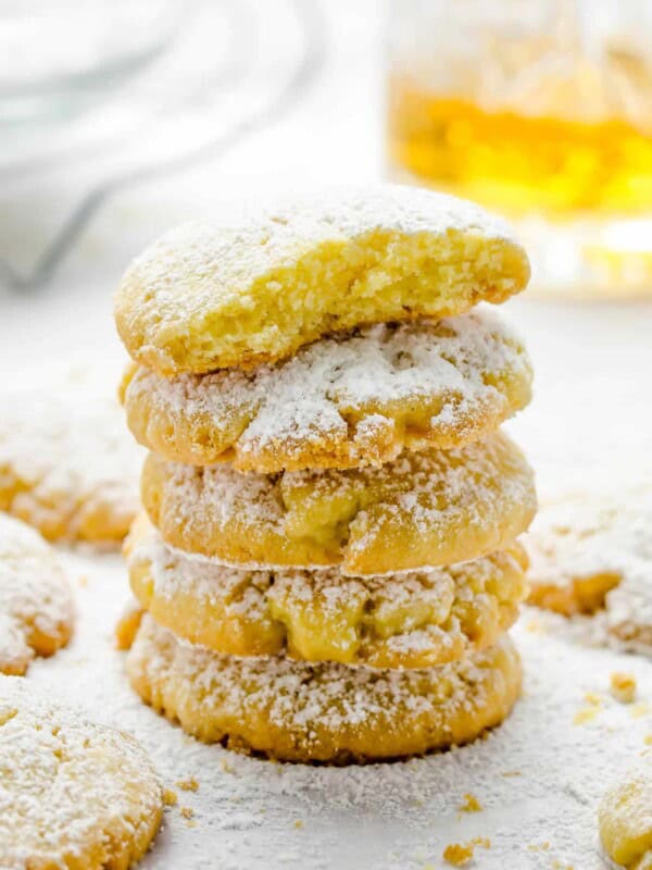 A stack of baked Gurabii shortbread cookies, with a bite missing from the top cookie.