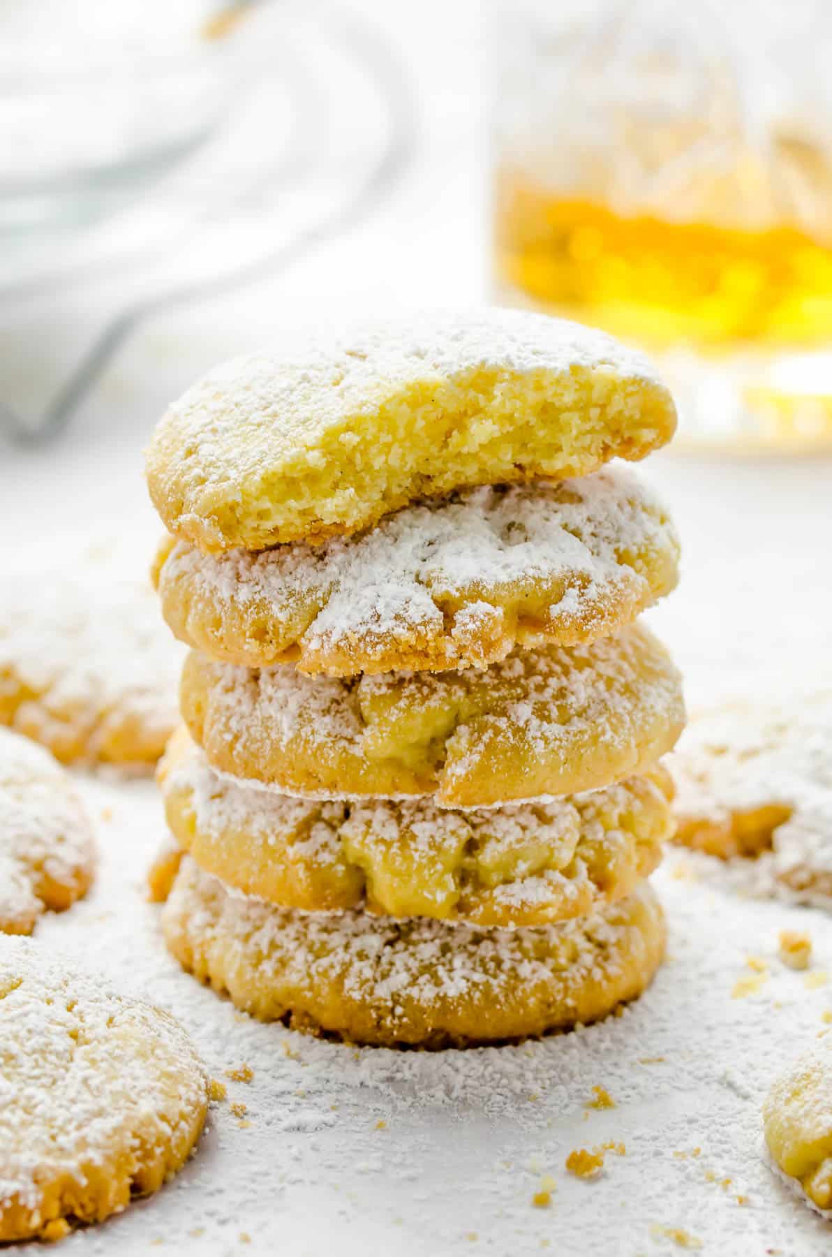 A stack of baked Gurabii shortbread cookies, with a bite missing from the top cookie.