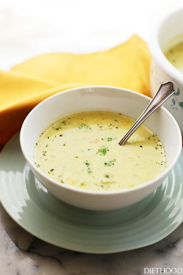 Broccoli Cheese Soup in a white soup bowl with a spoon