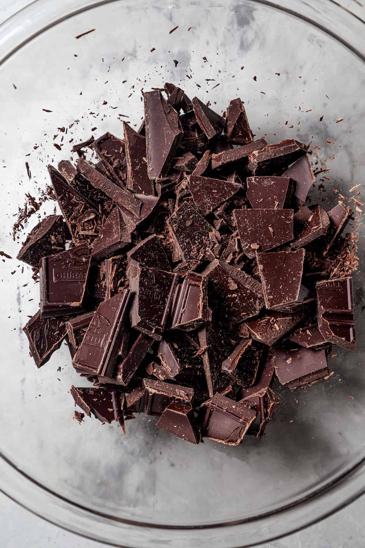 Chopped semisweet chocolate in a glass bowl.