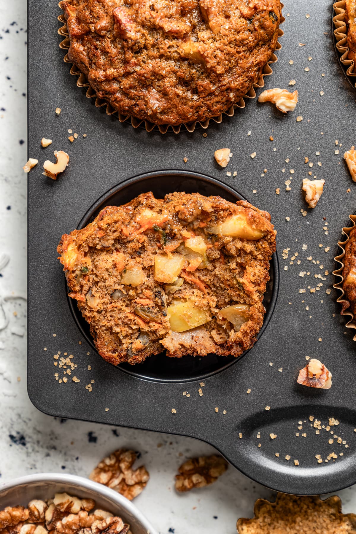 Halved morning glory muffin in a pan.