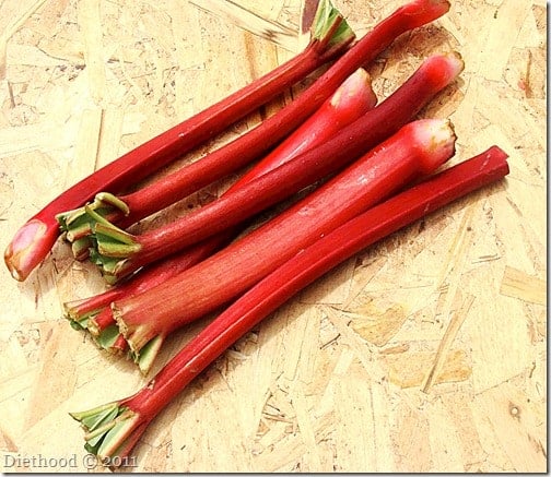 Rhubarb stalks on a wooden surface