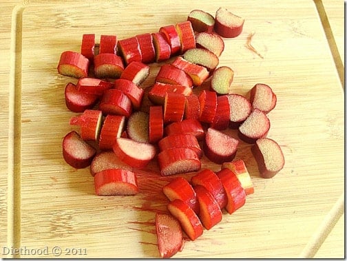 Sliced rhubarb on a wooden cutting board