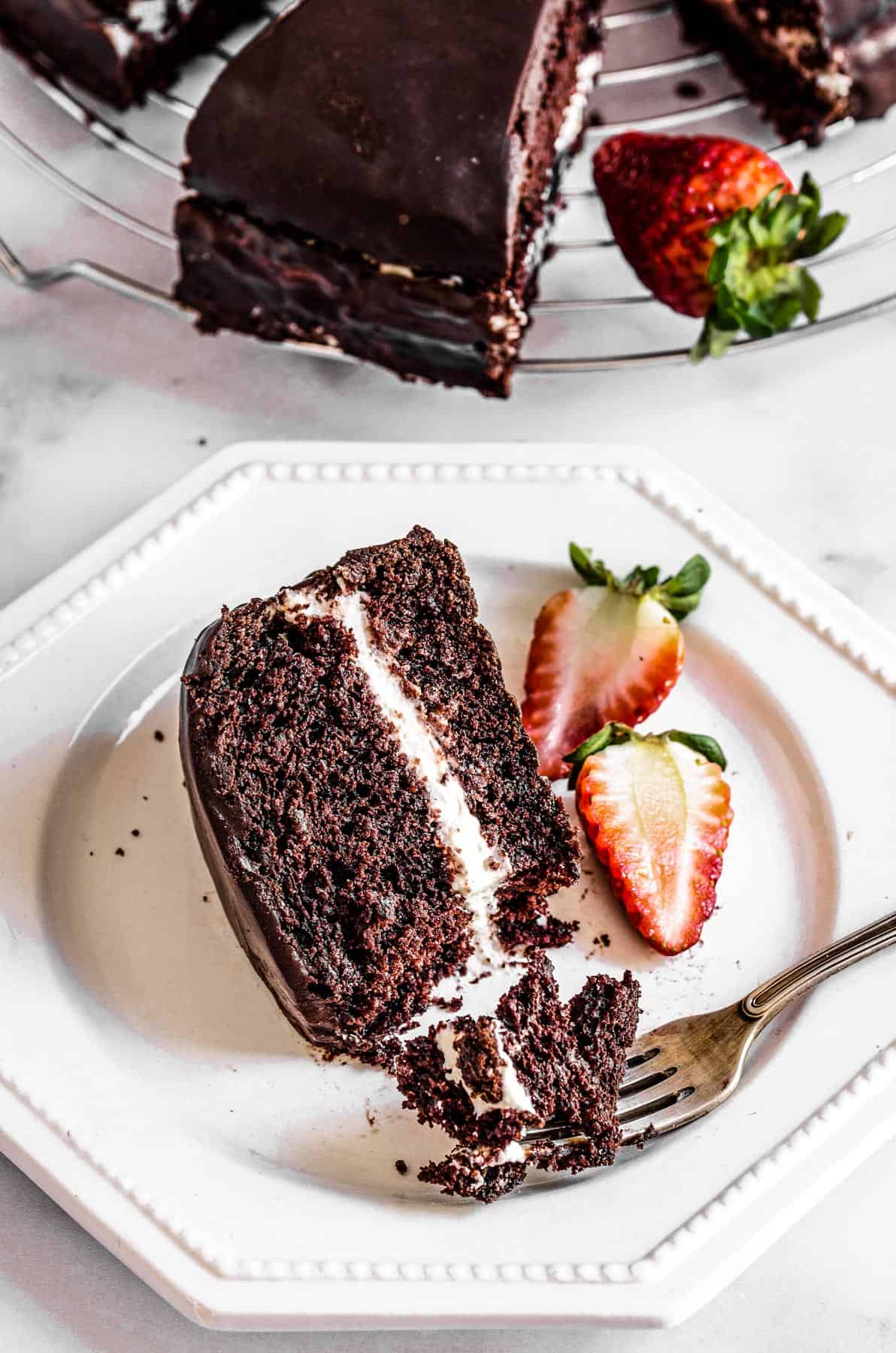 A slice of chocolate olive oil cake with strawberries.