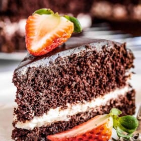 A slice of chocolate olive oil cake topped with strawberries.