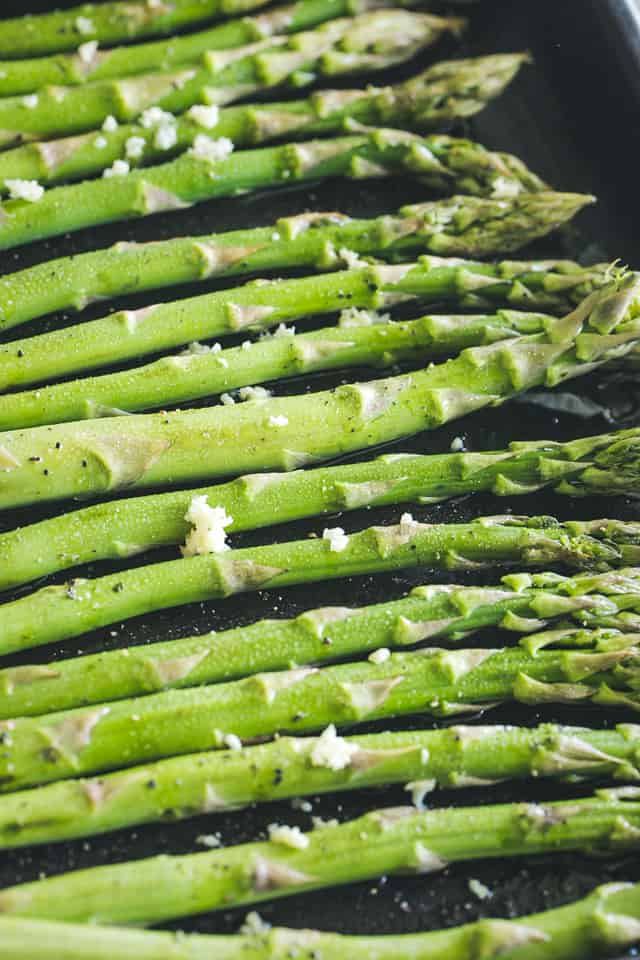 Garlic Roasted Asparagus with Bacon and Cheese - Our Garlic Roasted Asparagus is made with just a few simple ingredients, PLUS bacon and cheese,  and makes for a delicious side dish with any meal! 