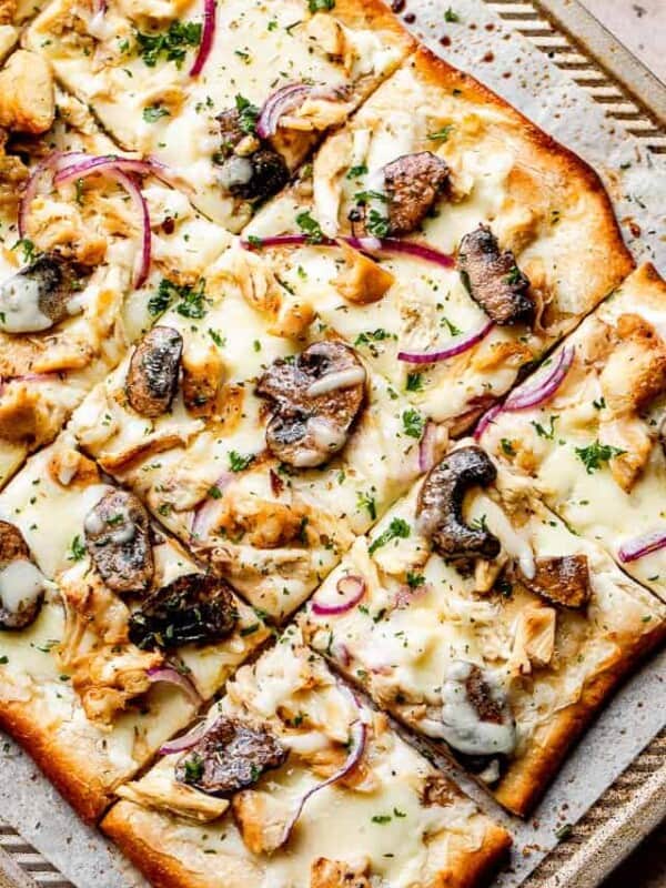 grilled pizza with toppings set on top of a baking sheet