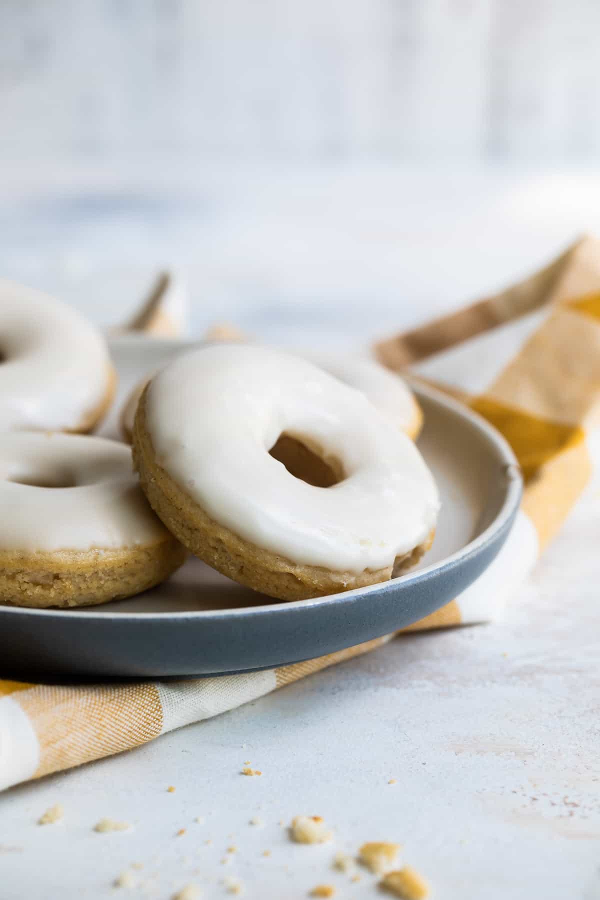 Plate of vanilla-glazed cinnamon donuts.