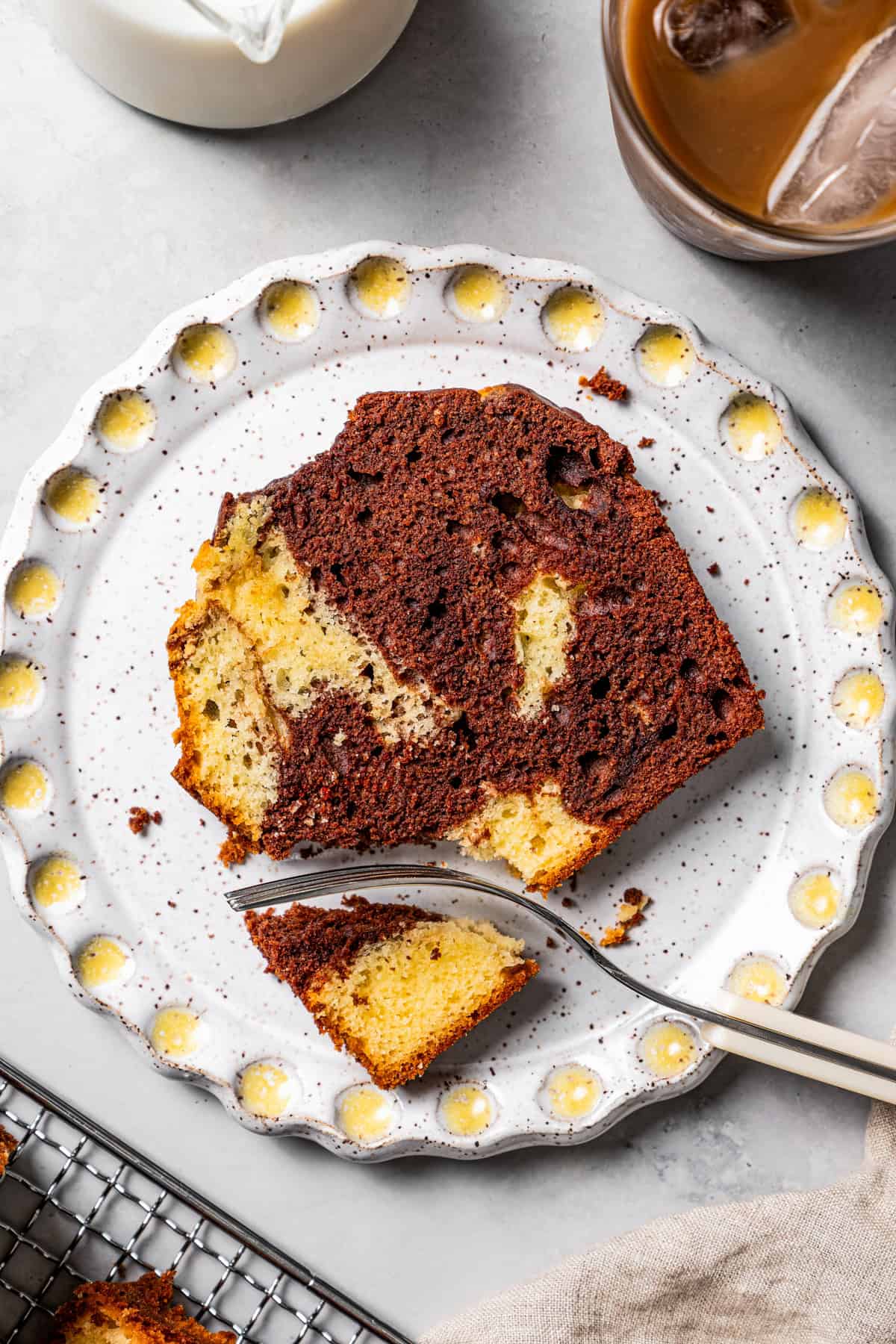 A fork cutting into a slice of loaf cake.