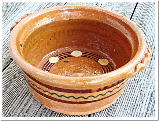 Macedonian clay baking pot on a wooden surface