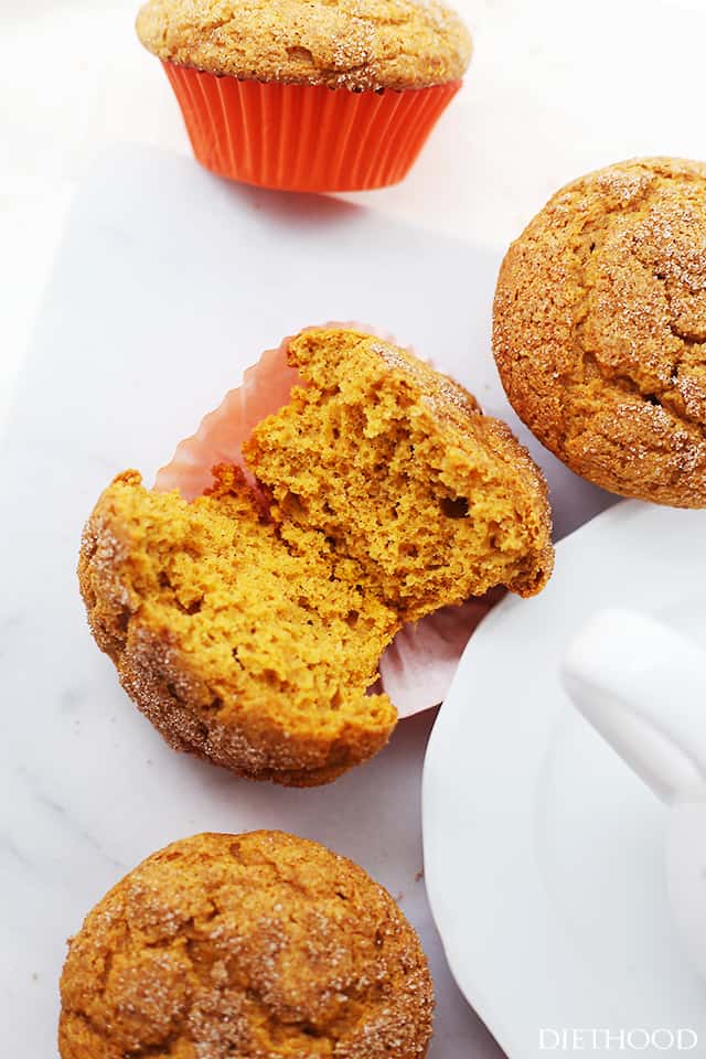 A fluffy, tender pumpkin muffin in two halves, ready to be topped with butter or as is!