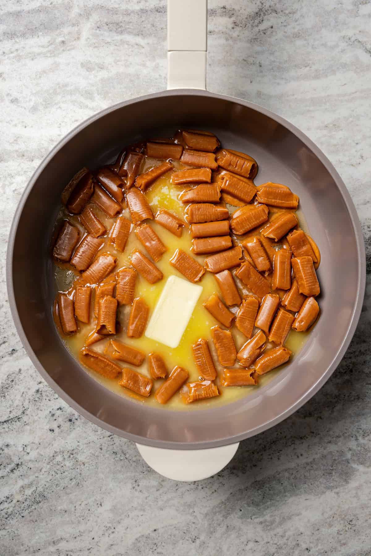 Caramel candies melting in a saucepan.