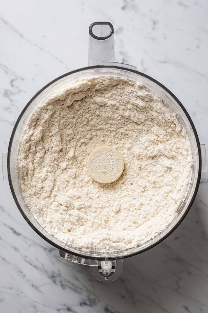 Flour, salt, and butter mixed together in a food processor