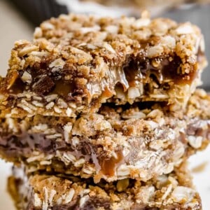 Close up of three carmelitas stacked, with a bite missing from the top bar.