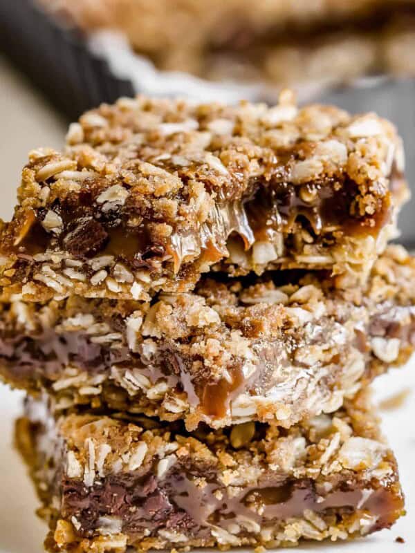 Close up of three carmelitas stacked, with a bite missing from the top bar.