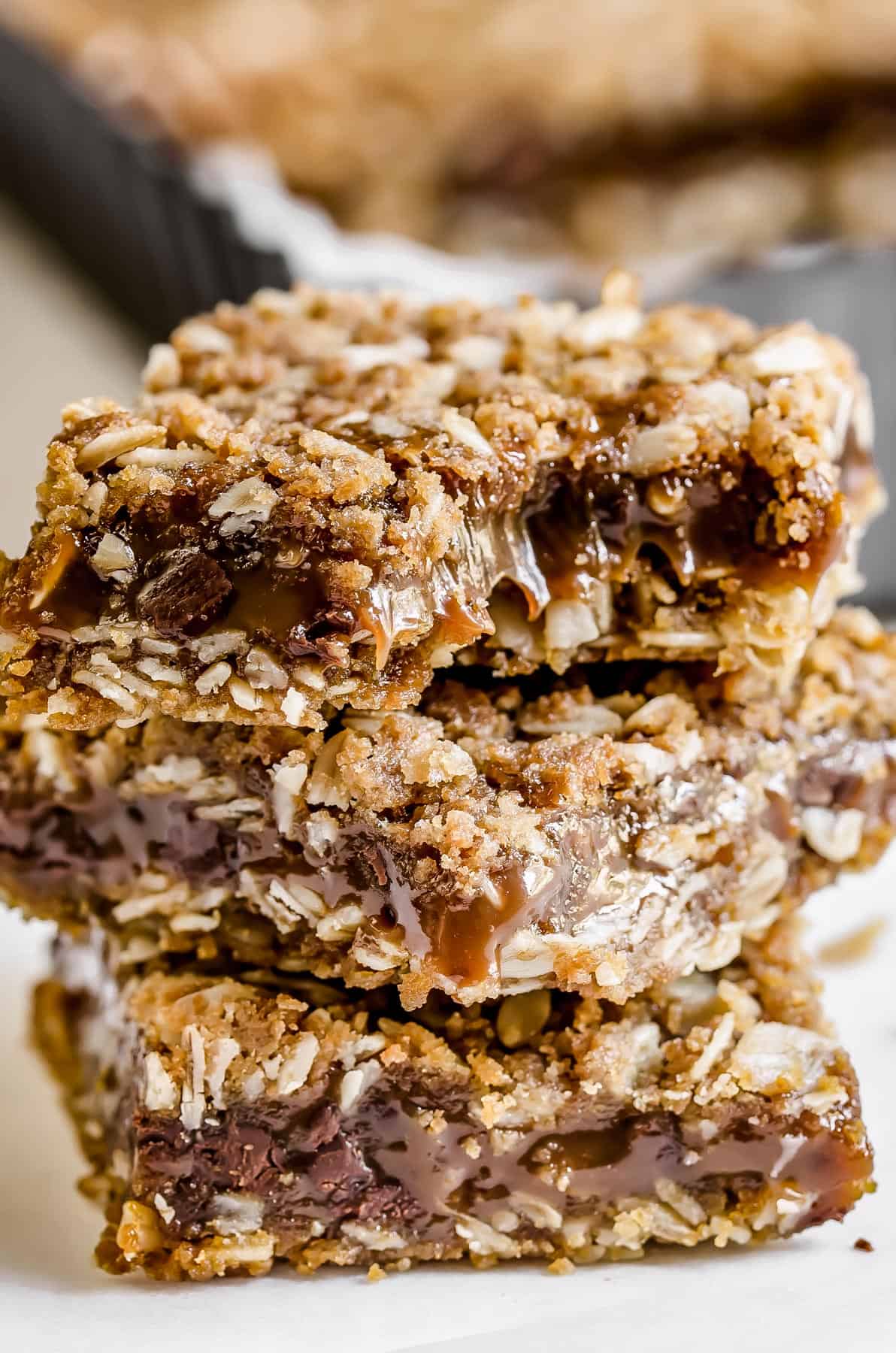 Three carmelitas stacked in front of a pan