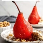 Red poached pear on a plate