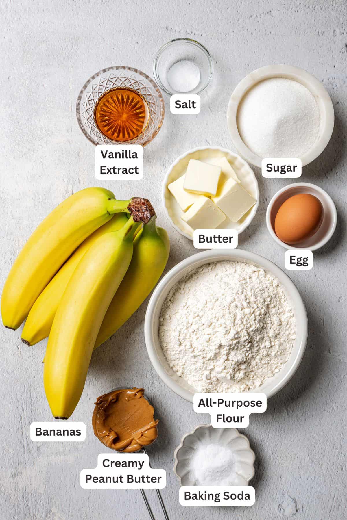 Peanut butter banana bread ingredients with text labels overlaying each ingredient.