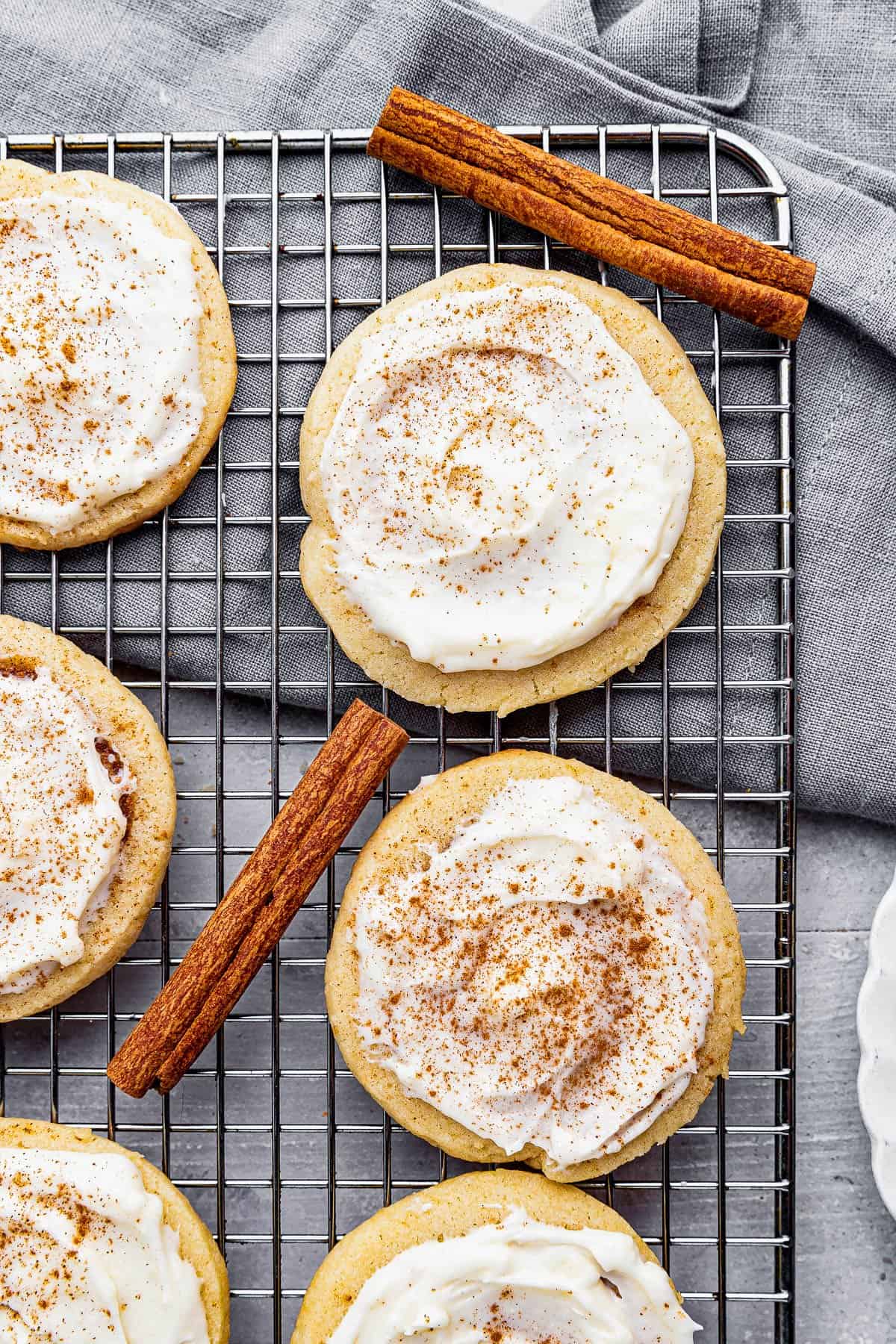 A Close-Up Shot of Frosted Cinnamon Swirl Cookies on a Metal Cooling Rack