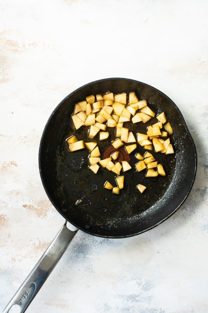 Fried apples in a skillet.