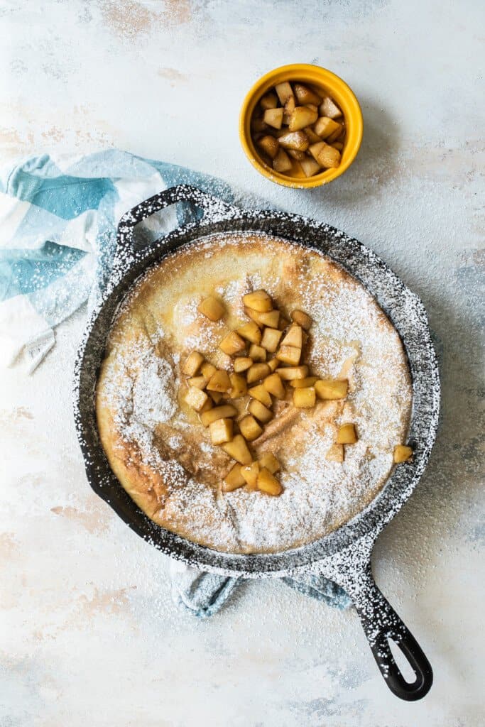 Dutch baby pancake topped with fried apples.