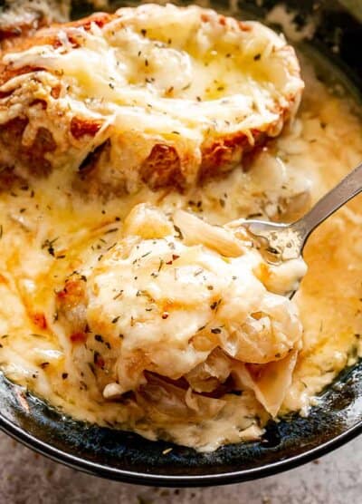 Crockpot French onion soup in a spoon.