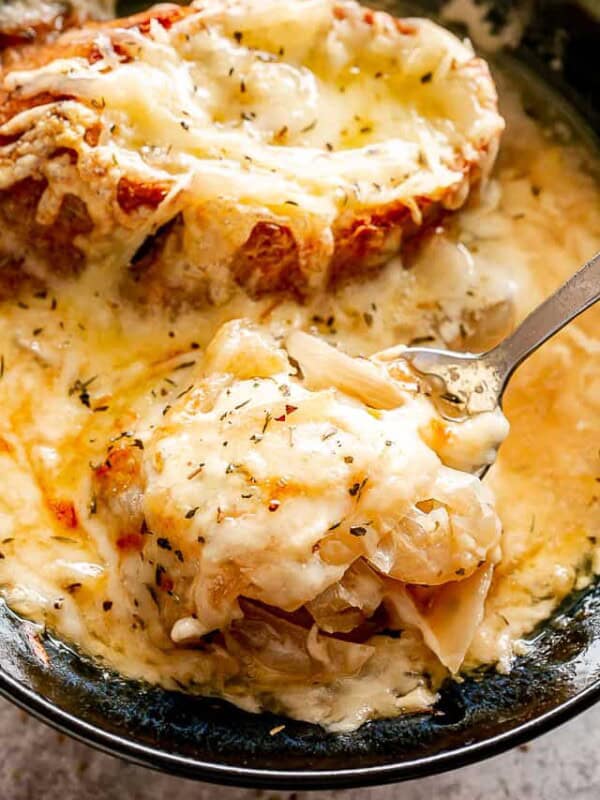 Crockpot French onion soup in a spoon.