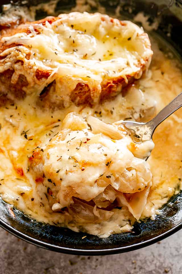 Crockpot French onion soup in a spoon.