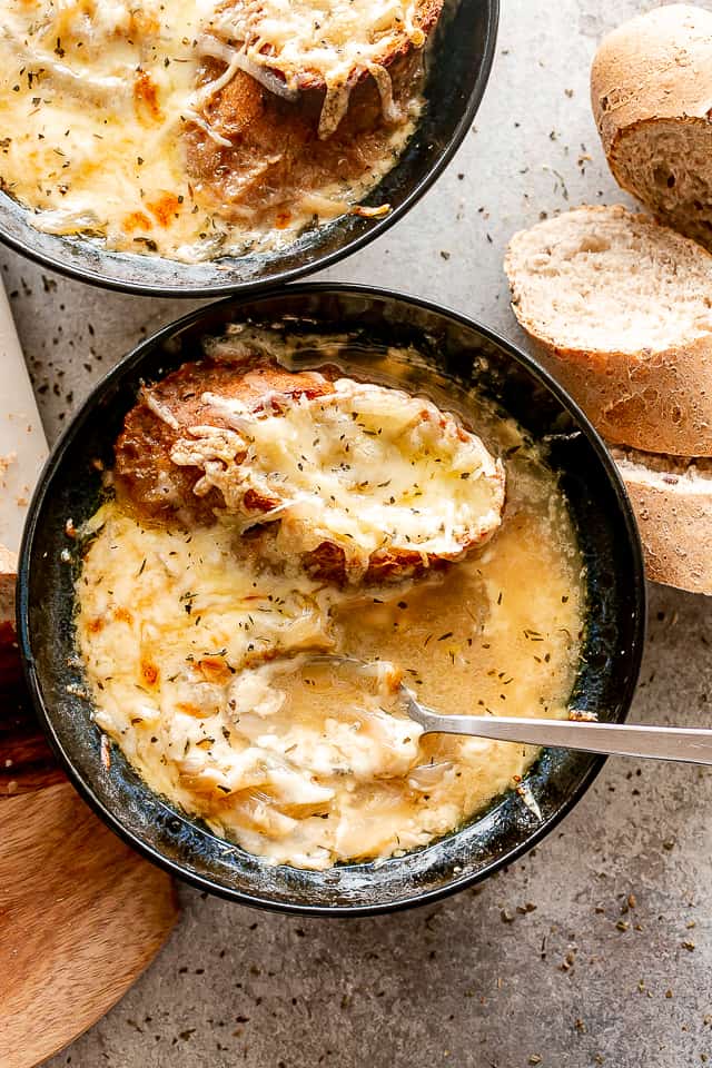 Crockpot French onion soup with melted cheese and French bread.