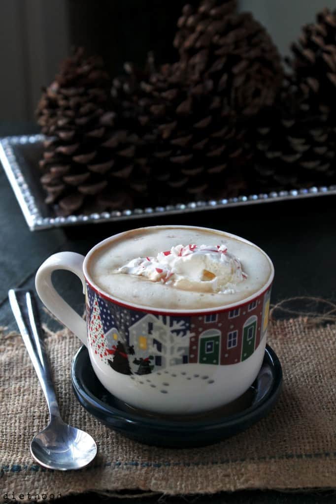 A festive mug filled with Peppermint White Chocolate Mocha Latte with crushed peppermint on top