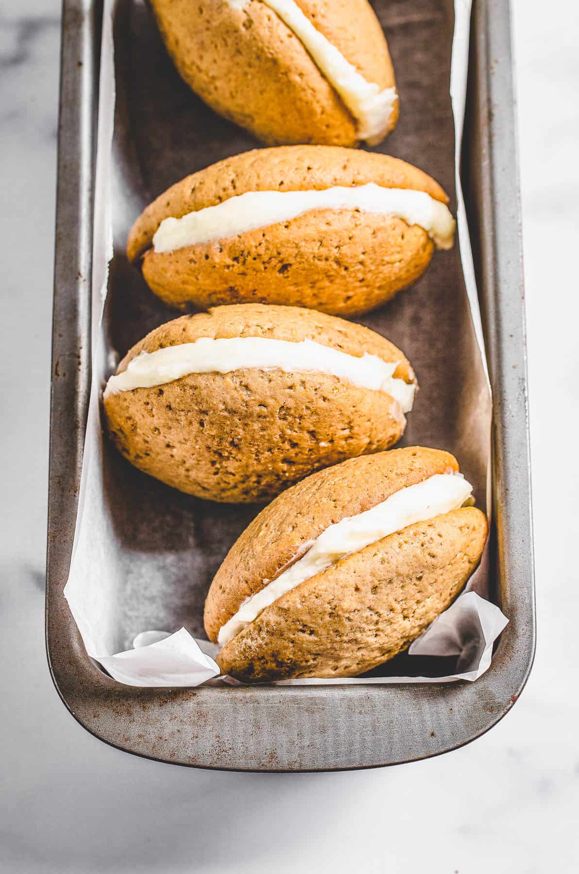 Gingerbread whoopie pies with vanilla buttercream filling.
