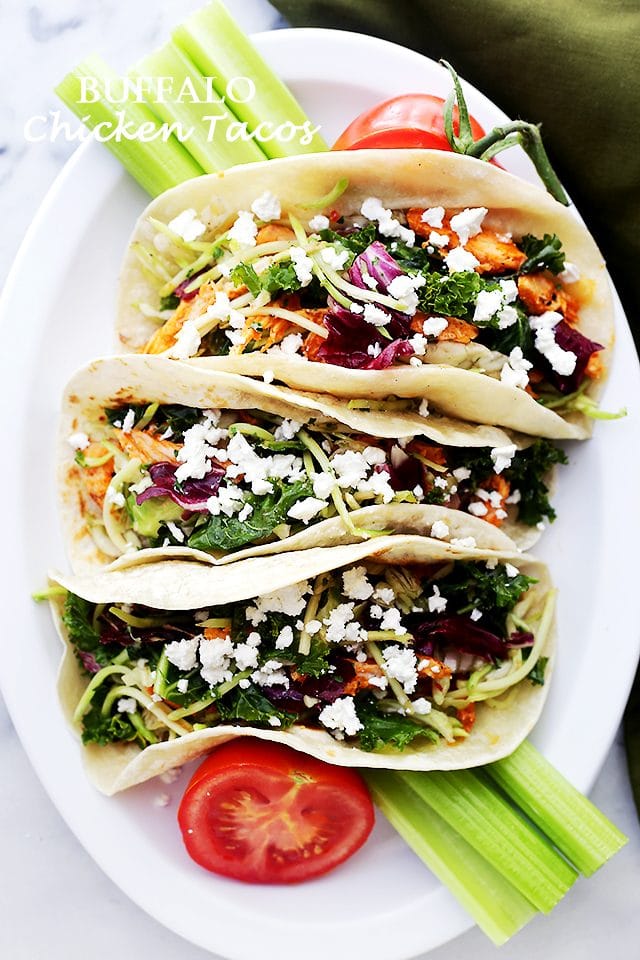Shredded Buffalo Chicken Tacos - Stuffed with the most incredible and spicy chicken, and loaded with a delicious broccoli slaw and feta cheese, this recipe is a must-have for busy weeknights!
