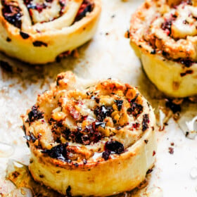 Honey is drizzled over freshly baked cranberry pinwheel cookies.