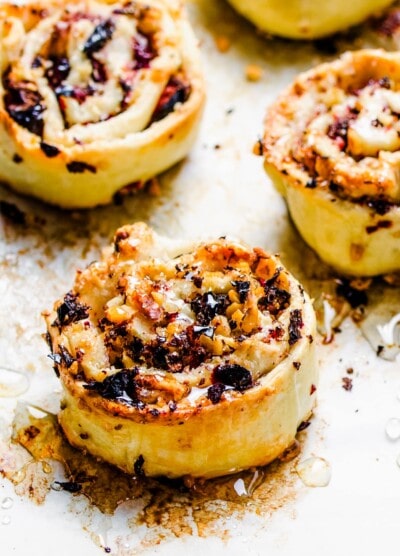 Honey is drizzled over freshly baked cranberry pinwheel cookies.